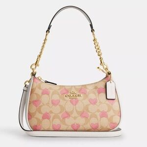 Coach Teri purse with Pink hearts.        Shoulder/crossbody purse!
